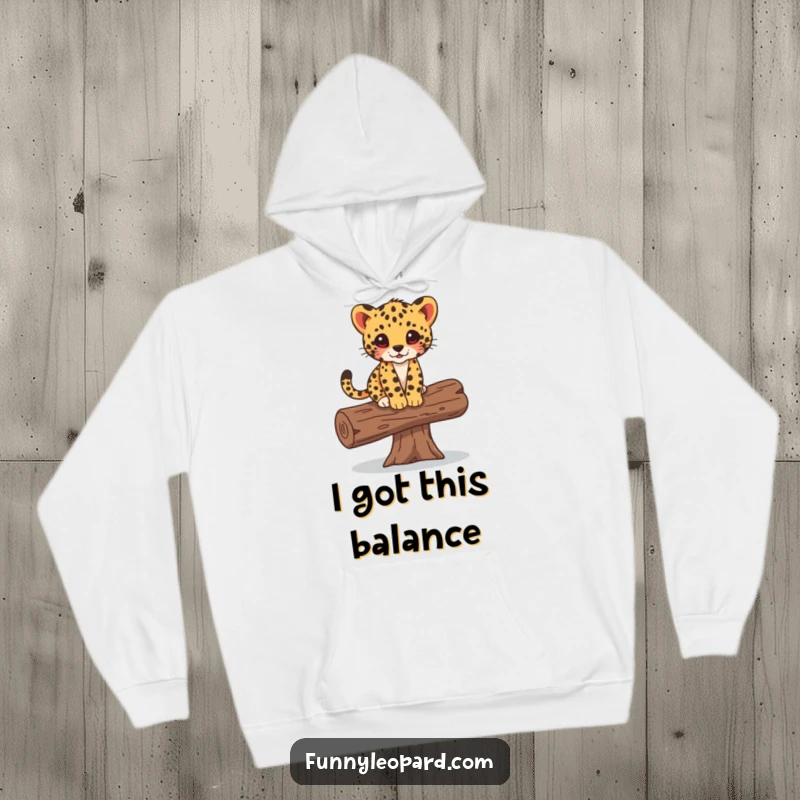 Funny hoodie illustrating a cute leopard cub balancing with playful ease on a fallen log, bringing warmth and cheer.