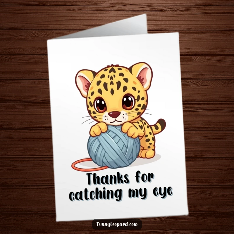 Funny Free Printable Thank You Card: A cute leopard cub with wide eyes playfully pounces on a yarn ball, sending thanks.