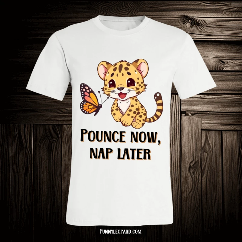 Funny t-shirt with a happy leopard cub character playfully pouncing on a butterfly, exuding pure joyful energy.
