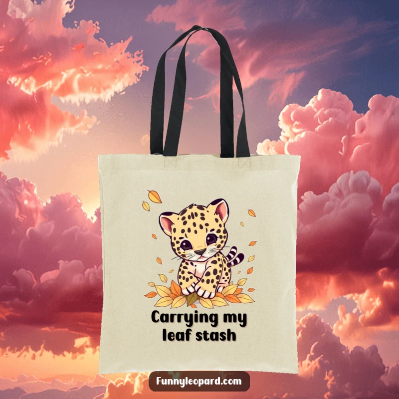 Funny tote bag illustrating a dynamic leopard cub leaping playfully into a drift of colorful autumn leaves, ideal for everyday use.